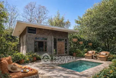 Charming garden view with cozy poolside seating and rustic cottage ambiance.