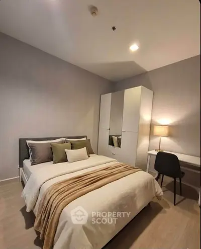 Cozy modern bedroom with stylish decor and ample storage space