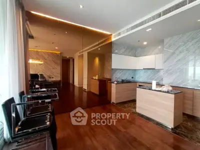 Luxurious modern kitchen with sleek cabinetry and elegant marble backsplash in open layout design.