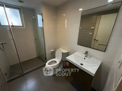 Modern bathroom with glass shower and sleek fixtures