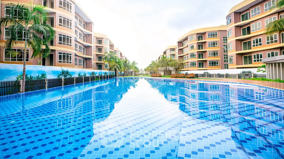 Luxurious apartment complex with stunning outdoor pool and modern architecture.