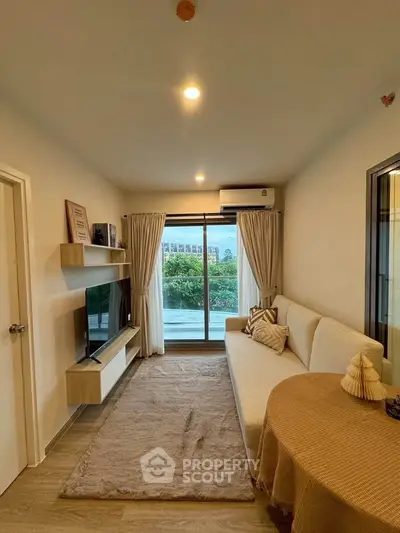 Modern living room with large window and stylish decor, offering a cozy and inviting atmosphere.