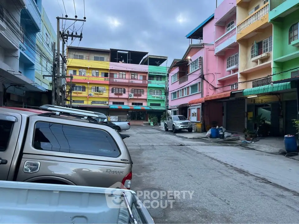 Colorful residential buildings with parked cars in a vibrant neighborhood