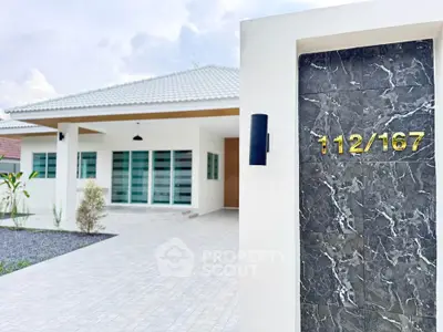 Modern single-story house with sleek exterior and stylish entrance
