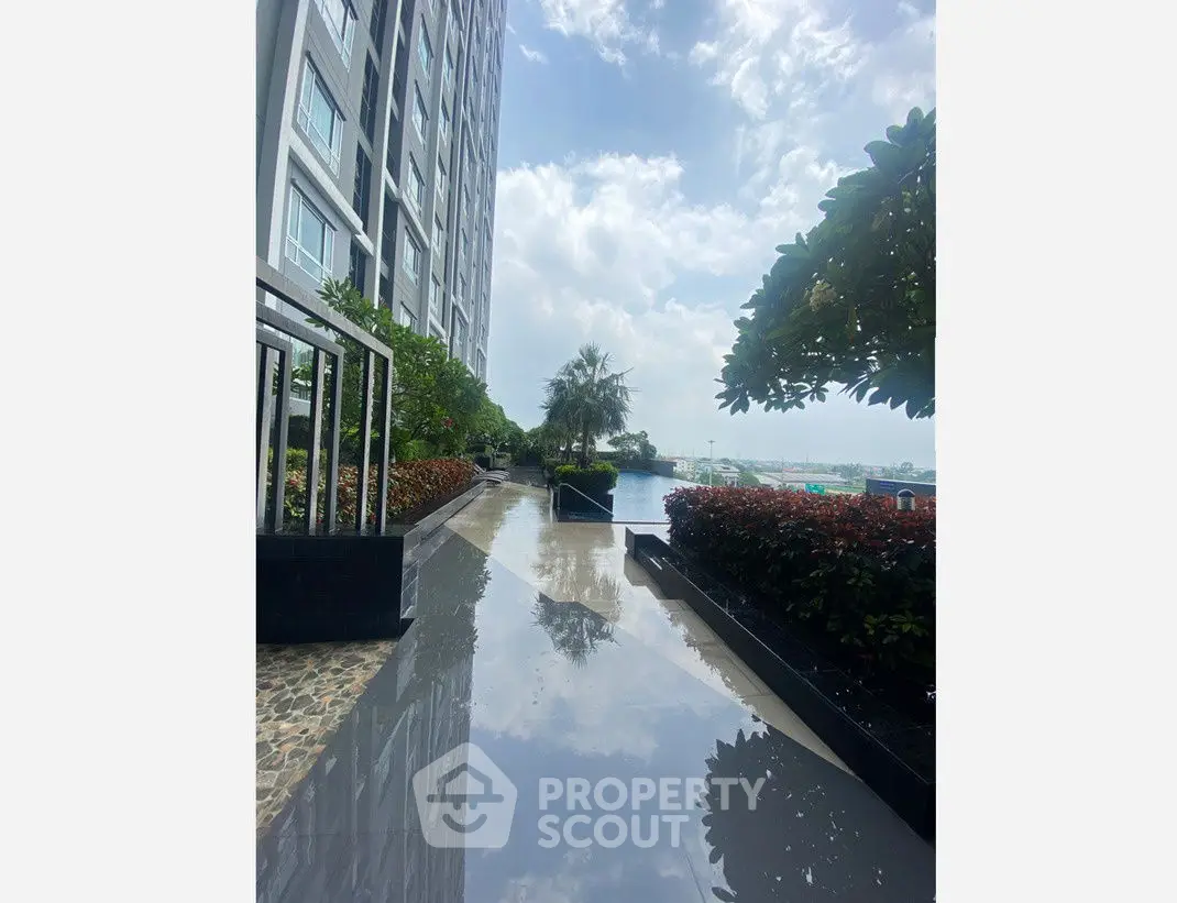 Luxurious high-rise building with stunning poolside view and lush greenery