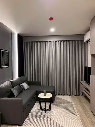Modern living room with sleek gray sofa and stylish decor