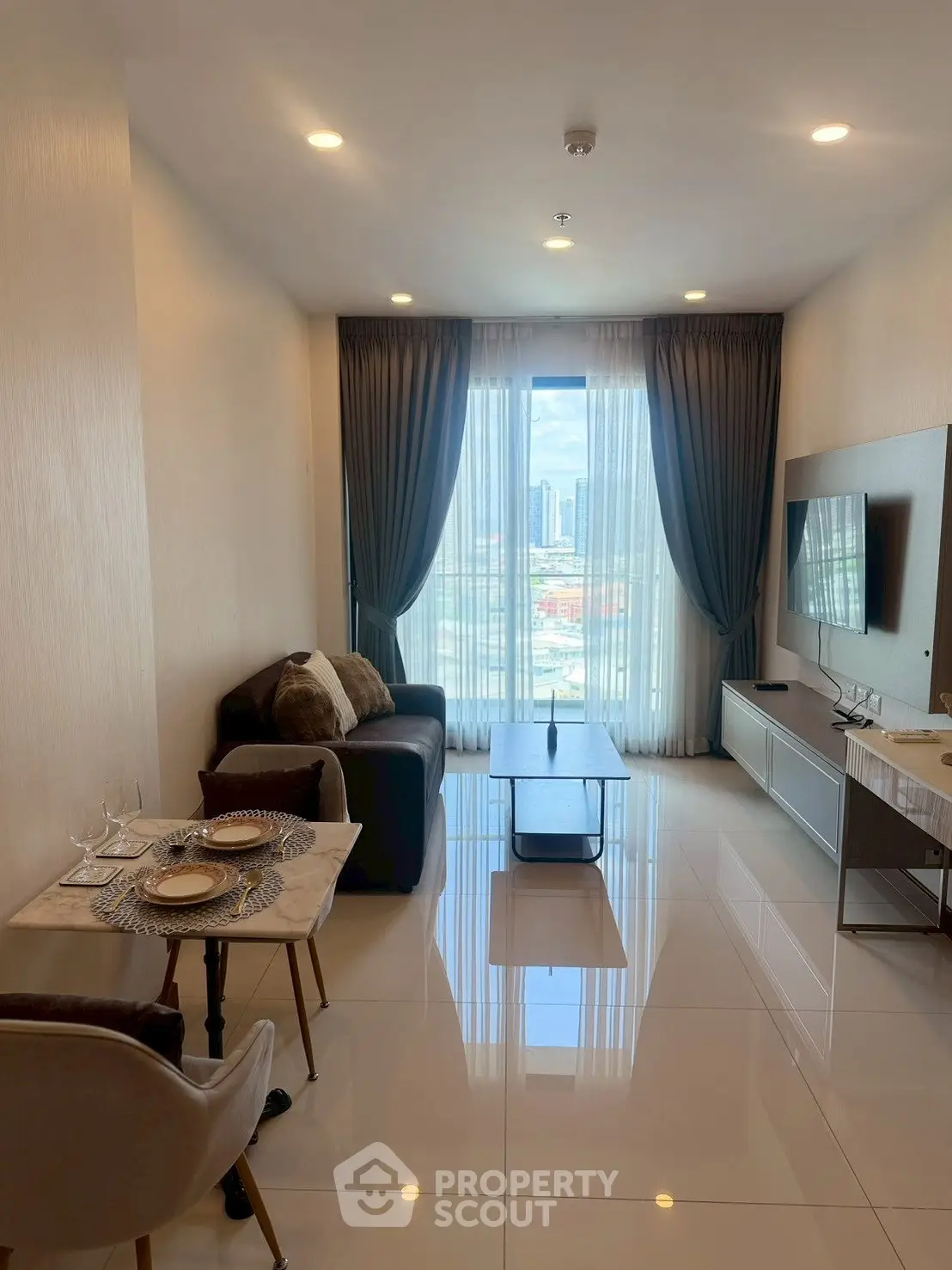 Modern living room with sleek furniture and city view, perfect for urban living.