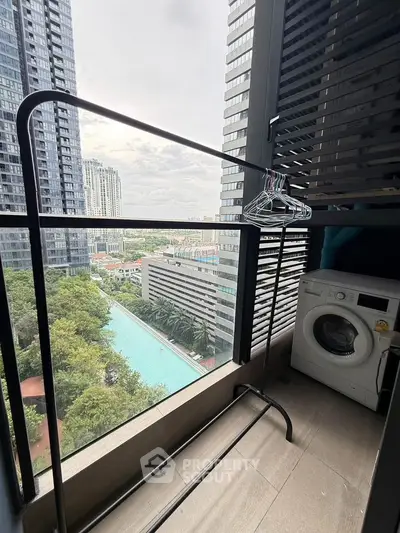 Modern balcony with city view, washing machine, and pool view in high-rise apartment.