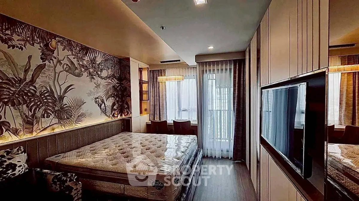 Luxurious bedroom with stylish decor and large window offering natural light.