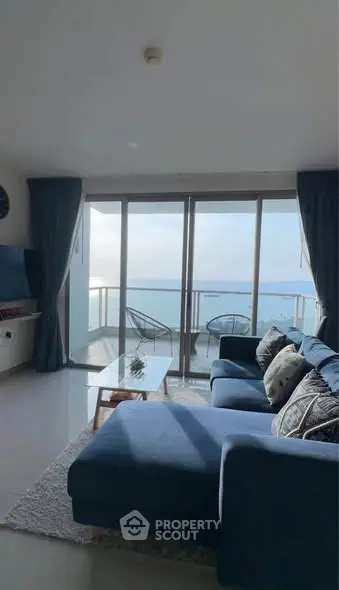 Stunning living room with ocean view and spacious balcony in modern apartment