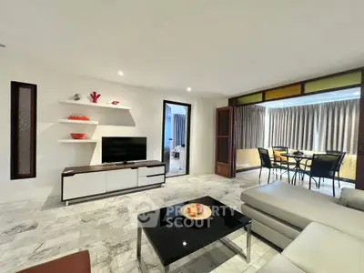 Spacious modern living room with sleek furniture and dining area, perfect for entertaining.