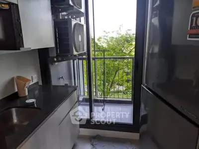 Modern kitchen with balcony view and sleek appliances in urban apartment