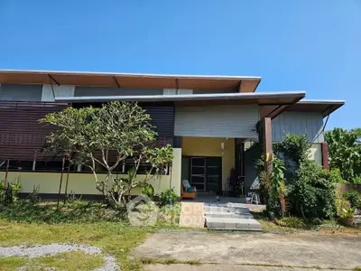 Modern single-story house with unique architectural design and lush greenery, perfect for serene living.