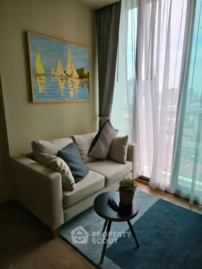 Cozy living room with modern decor and city view, featuring a comfortable sofa and stylish artwork.