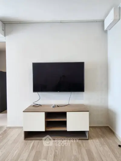 Modern living room with mounted TV and stylish wooden cabinet