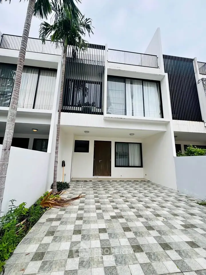 Modern townhouse exterior with sleek design and spacious driveway