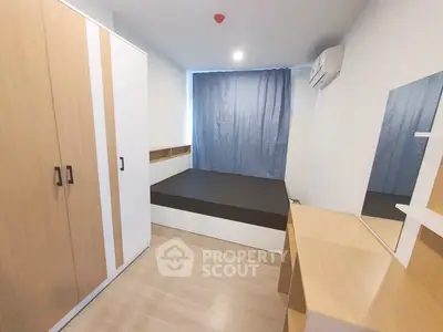 Modern bedroom with minimalist design, featuring a bed, wardrobe, and desk in a cozy setting.