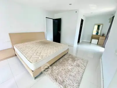 Spacious modern bedroom with minimalist decor and natural light