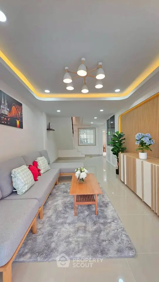 Modern living room with stylish decor, cozy seating, and elegant lighting in a contemporary home.