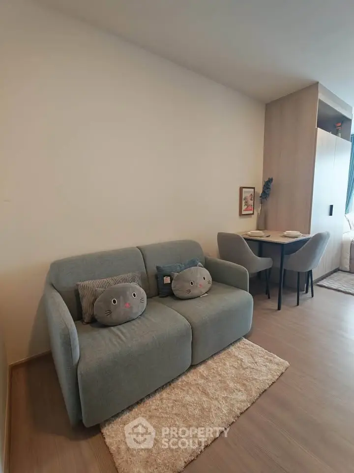Cozy living room with modern sofa and dining area in stylish apartment