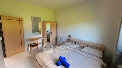 Cozy bedroom with modern furniture and natural light, perfect for relaxation.