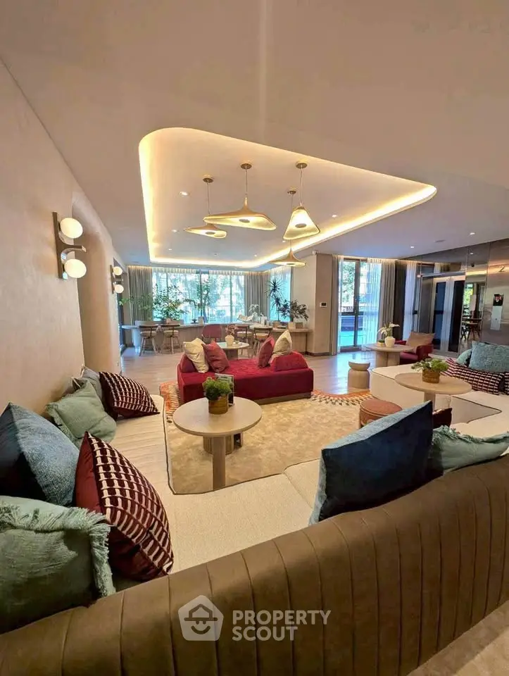 Luxurious living room with modern decor and ample natural light, perfect for relaxation and entertainment.