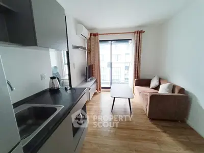 Modern living room with open kitchen and balcony view