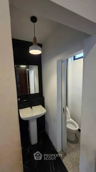 Modern bathroom with sleek black tiles and contemporary fixtures