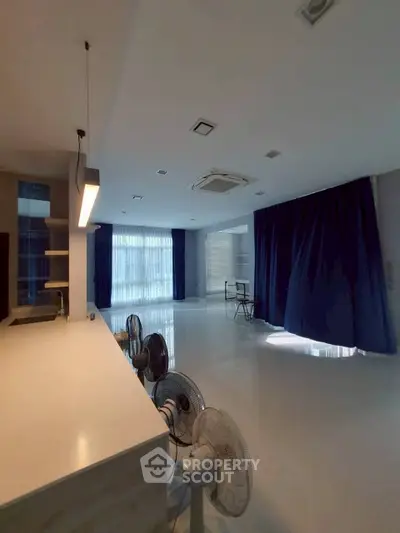 Spacious modern living room with sleek design and large windows