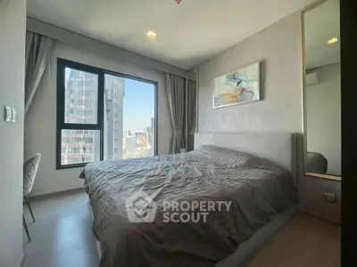 Modern bedroom with large window offering city view, stylish decor, and cozy ambiance.