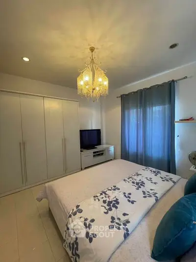 Cozy bedroom with elegant chandelier and stylish decor