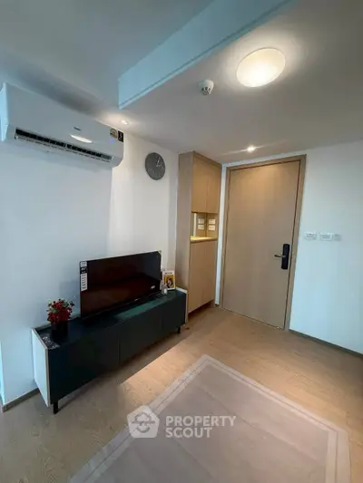 Modern living room with sleek furniture and air conditioning unit