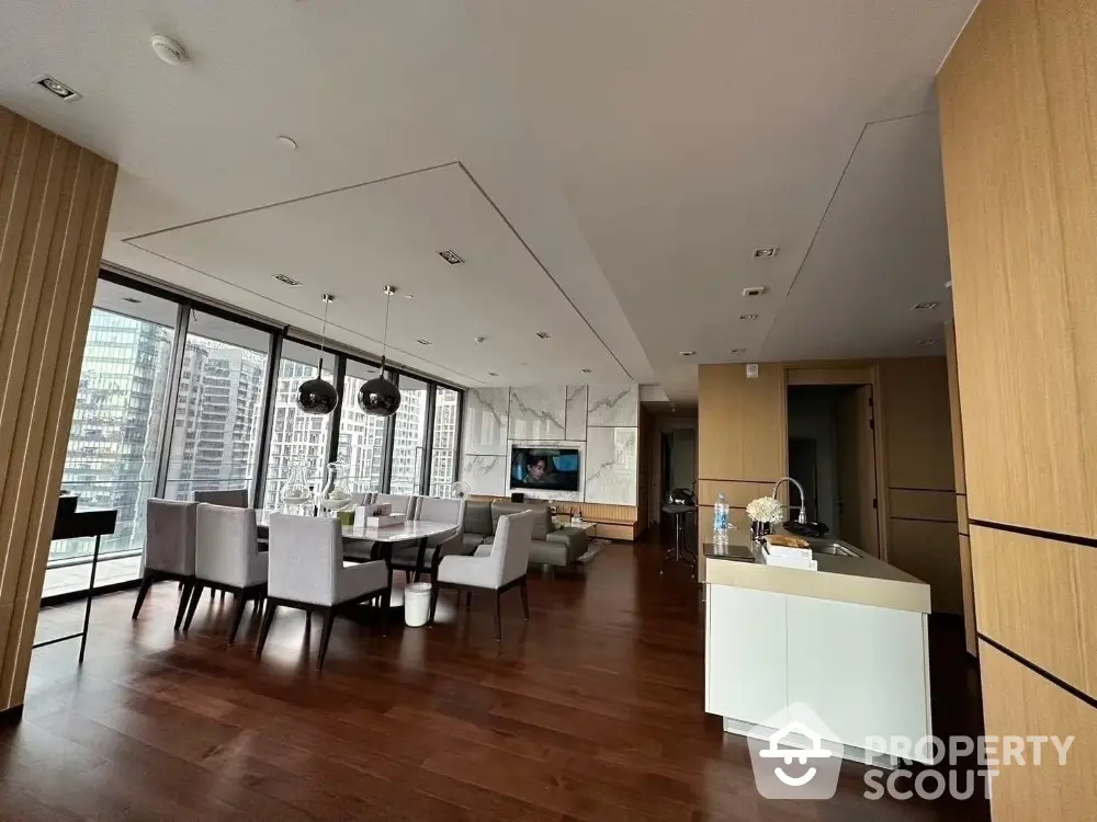 Luxurious open-plan living and dining area with modern kitchen and stunning city views.