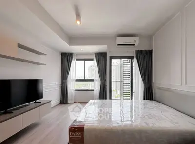 Modern bedroom with city view, featuring sleek design and natural light, perfect for urban living.