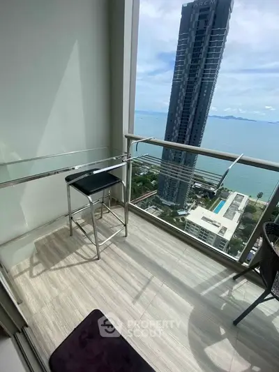 Stunning high-rise balcony with ocean view, perfect for relaxation and enjoying the cityscape.