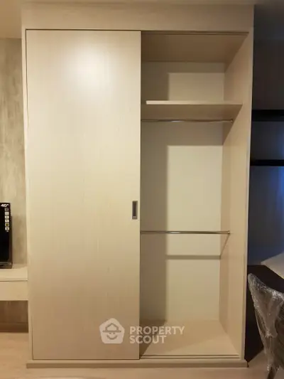 Spacious built-in wardrobe with sliding doors in modern interior design.