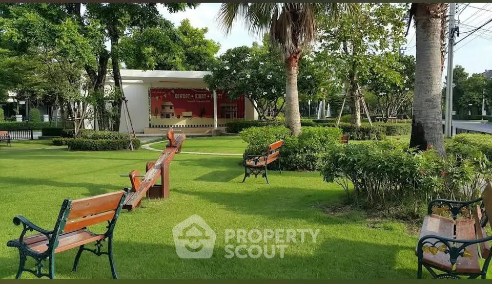 Beautiful garden area with benches and lush greenery in a serene neighborhood park.