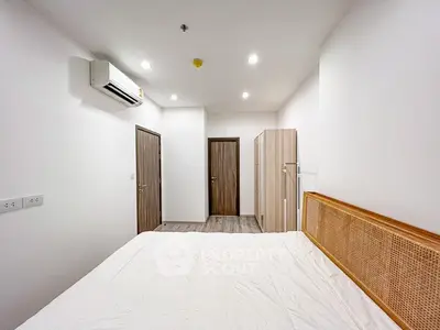 Spacious bedroom with modern design and ample storage in a stylish apartment.