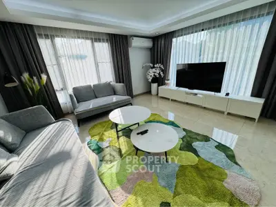 Spacious modern living room with stylish decor and large windows