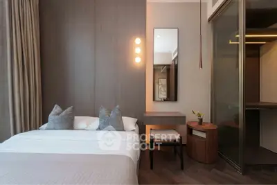 Modern bedroom with sleek design, featuring a cozy bed, stylish lighting, and elegant decor.