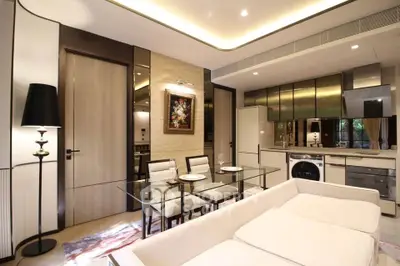 Luxurious modern living room with open kitchen, elegant decor, and stylish furniture in a contemporary apartment.