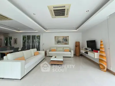 Spacious modern living room with elegant decor and ample natural light.
