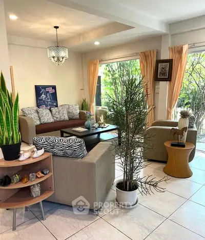 Charming living room with cozy seating and lush garden view