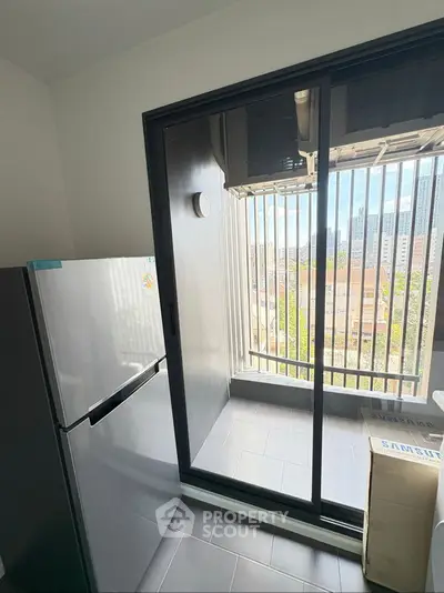 Modern balcony with glass railing and city view, perfect for relaxation and enjoying the skyline.