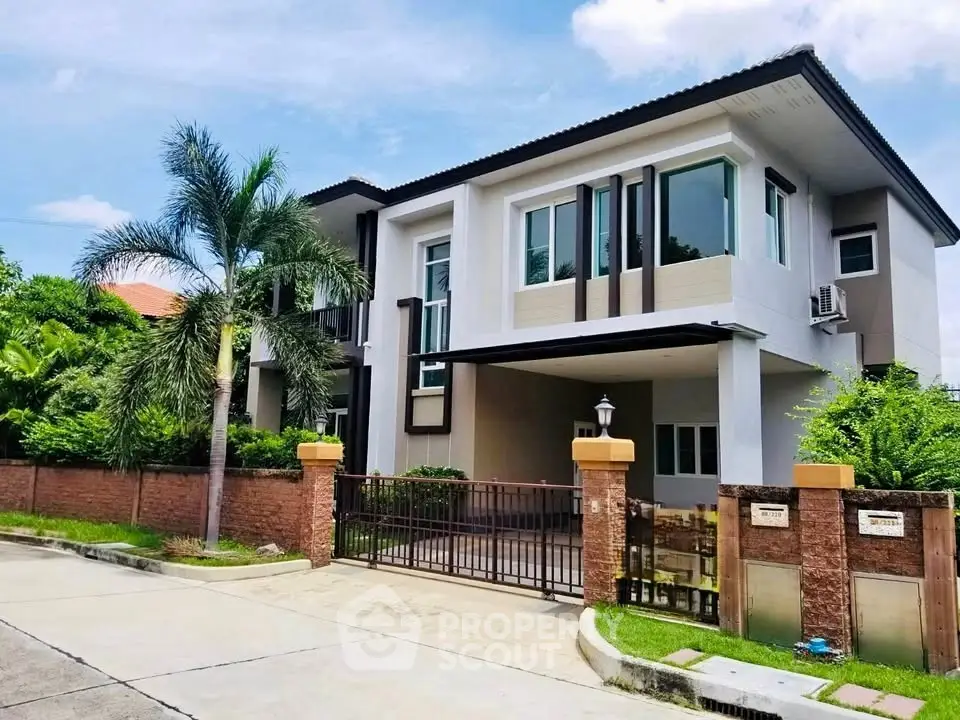 Modern two-story house with lush greenery and spacious driveway in a serene neighborhood.