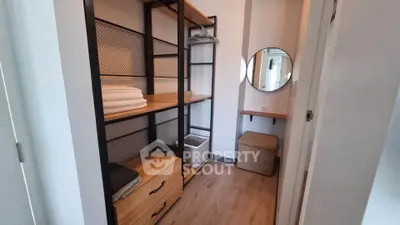 Modern storage room with wooden shelves and mirror, perfect for organizing essentials.