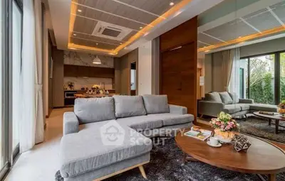 Luxurious modern living room with elegant decor and open kitchen layout, perfect for stylish living.