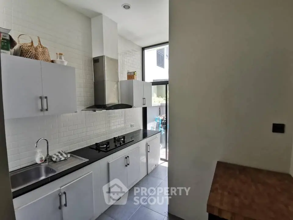Modern kitchen with sleek cabinets and gas stove in bright natural light