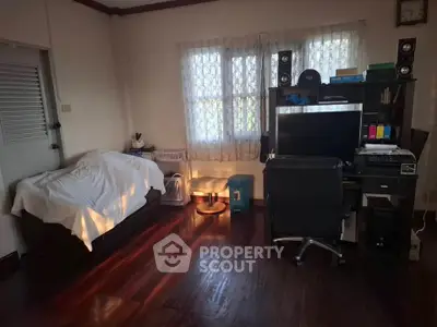 Cozy study room with desk, chair, and natural light through window.