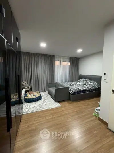 Spacious bedroom with modern furnishings and cozy pet area